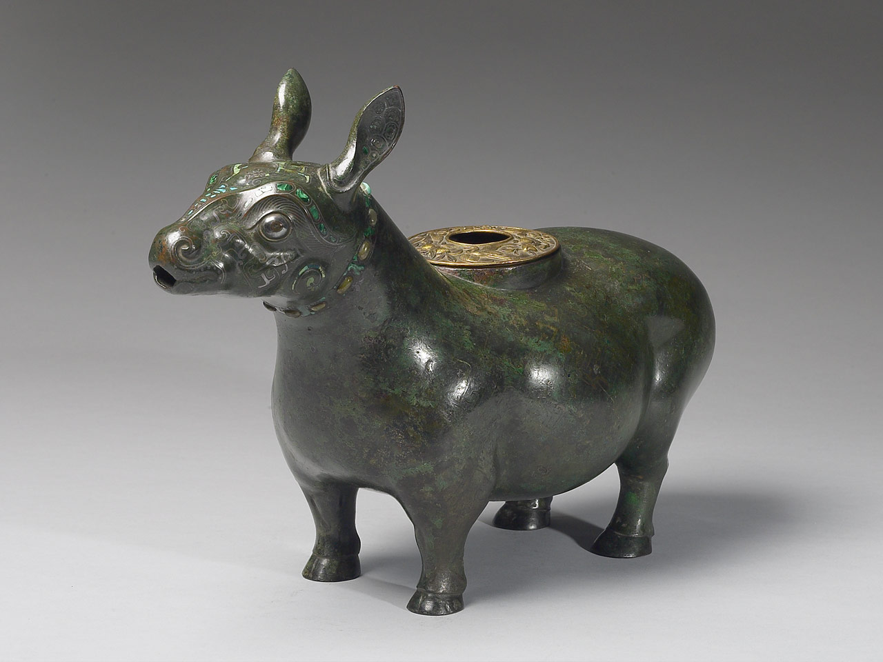Zun wine vessel in the shape of animal with malachite and turqoise inlay, Mid Warring States Period