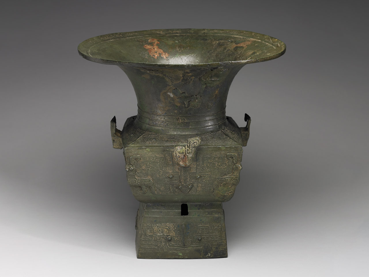 Square Zun wine vessel with round mouth, animal heads, and animal mask pattern, Late Shang Dynasty
