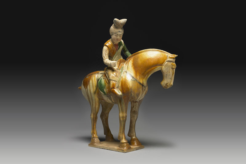 Pottery figure of ladies playing polo game in sancai tri-color glaze