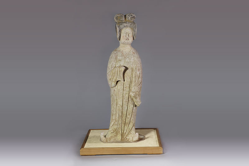 Pottery figure of a standing lady with painted colors