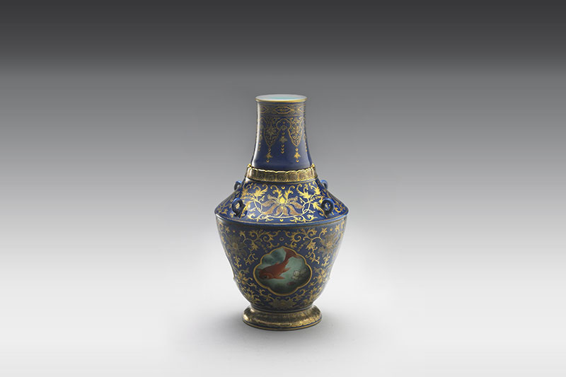 Revolving vase with swimming fish in cobalt blue glaze